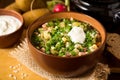 Okroshka. Traditional Russian summer cold soup with sausage, vegetables and kvass in bowl on wooden background. Royalty Free Stock Photo