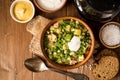 Okroshka. Traditional Russian summer cold soup with sausage, vegetables and kvass in bowl on wooden background. Royalty Free Stock Photo