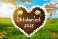 Oktoberfest Background Banner. Green meadow. Gingerbread heart . Destination panel. Sign post Royalty Free Stock Photo