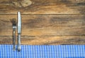 Cutlery with blue and white table cloth on rustic wood with copy space for menu card.