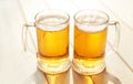 Oktoberfest beer. Glass beer mugs full of golden lager with thick frothy heads conceptual of Oktoberfest. Beer mug. Big glass of Royalty Free Stock Photo