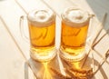 Oktoberfest beer. Glass beer mugs full of golden lager with thick frothy heads conceptual of Oktoberfest. Beer mug. Big glass of Royalty Free Stock Photo