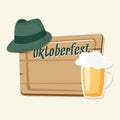 Oktoberfest card, invitation with beer, green hat and wooden board Royalty Free Stock Photo