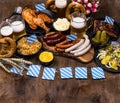 Oktoberfest dishes with beer, pretzel and sausage