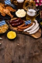 Oktoberfest dishes with beer, pretzel and sausage