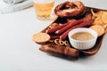 Oktoberfest food, appetizing beer snacks set for big company.Grilled sausages, chips, pretzel. Royalty Free Stock Photo