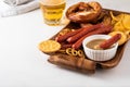 Oktoberfest food, appetizing beer snacks set for big company. Grilled sausages, salami, chips, pretzel crackers and