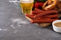 Oktoberfest food, appetizing beer snacks set for big company. Grilled sausages, salami, chips, pretzel crackers and Royalty Free Stock Photo