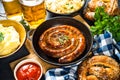 Oktoberfest food - sausage, sauerkraut, beer and bretzel.