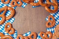 Oktoberfest German beer festival background with wooden board and pretzel.