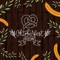 Oktoberfest lettering with wreath leafs in wooden background