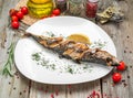 Oktoberfest menu. Grilled mackerel fish with beer and pretzel served Royalty Free Stock Photo