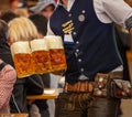 Oktoberfest, Munich, Germany. Waiter serving beers, closeup view Royalty Free Stock Photo