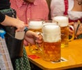 Oktoberfest, Munich, Germany. Waiter serving beers, closeup view Royalty Free Stock Photo