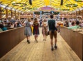 Oktoberfest, Munich, Germany. Waiter holding beers, tent interior background Royalty Free Stock Photo