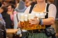 Oktoberfest, Munich, Germany. Waiter with traditional costume holding beers Royalty Free Stock Photo