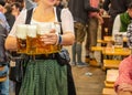 Oktoberfest, Munich, Germany. Waiter with traditional costume holding beers Royalty Free Stock Photo