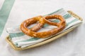 Oktoberfest salted soft pretzel on a plate on textile background