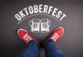 Oktoberfest sign with beer mugs and red sneakers. Royalty Free Stock Photo