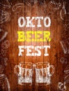 Oktoberfest sign, two beer mugs, chalk drawings, wooden background. Royalty Free Stock Photo