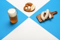 Oktoberfest table with a pint of beer, white sausage, and pretzel. Bavarian traditional meal