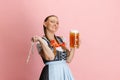 Adorable Oktoberfest woman, waitress wearing a traditional Bavarian or german dirndl holding one liter beer glass Royalty Free Stock Photo