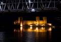 Olavinlinna stone castle and railroad bridge by night