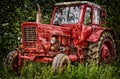 Old abandon red traktor in nature. Royalty Free Stock Photo