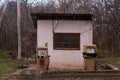 An old abandoned analog fuel station. Industrial zone or production area conquered by nature