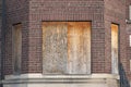 Abandoned apartment building with boarded up windows