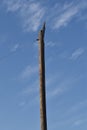 Old abandoned bare broken telephone electric pole with guy wire