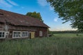 an old abandoned barn on a field Royalty Free Stock Photo