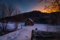 Old abandoned barn in the snow during the sunrise in Vermont Royalty Free Stock Photo