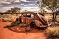 Old abandoned beetle style vehicle on a lonely road in the dusty, red arid land of outback Australia