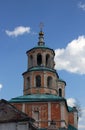 Old abandoned belfry of russian orthodox church in the classical style in orange color with green roof and dome, Torzhok, Russia Royalty Free Stock Photo