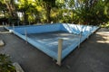 Old abandoned blue pool in the backyard. Dry unused swimming pool. autumn