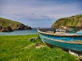 An old, abandoned, blue, wooden fishing boat near a beach in southern Shetland, UK. Royalty Free Stock Photo