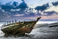 Old abandoned boat on the beach at sunset Royalty Free Stock Photo