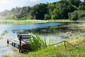 An old abandoned boat on the pond. Beautiful scenic landscape on the Tyasmin river, Kamyanka, Ukraine. Travel by Ukraine Royalty Free Stock Photo