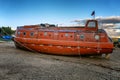 Old abandoned boat on the shore .Orange submarine. Gloomy northern nature
