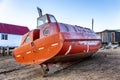 Old abandoned boat on the shore .Orange submarine. Gloomy northern nature