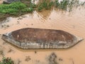 Old abandoned boat upside down in a muddy pond