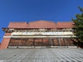 Old abandoned brick building looking up roof metal tin clear blue sky Royalty Free Stock Photo