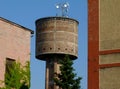 Old abandoned brick water tower detail with radio transmission antenna on top
