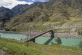 Old abandoned bridge over the river Katun, Altai, Russia. Royalty Free Stock Photo