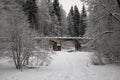 An old abandoned bridge in a winter park. Snowy winter day. Royalty Free Stock Photo