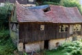 Old abandoned and broken barn with broken windows and roof