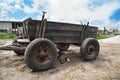 Old abandoned broken cart is on a green autumn field in the countryside. Royalty Free Stock Photo