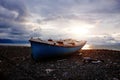 Old abandoned broken fishing boat on sea shore at sunset Royalty Free Stock Photo