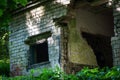 Old abandoned white brick building with squared window holes